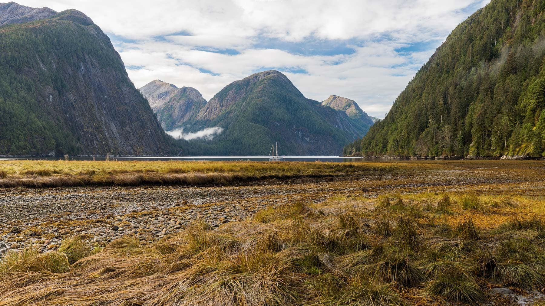schooner-passing-cloud-anchored-fiordland-great-bear-rainforest