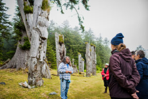 A Haida Watchment talks to Outer Shores Expeditions' guests at SGang Gwaay UNESCO World Heritage Site